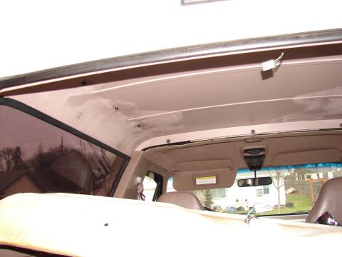 1996 Ford Bronco - Interior view of a vehicle, focusing on the headliner and surrounding components.