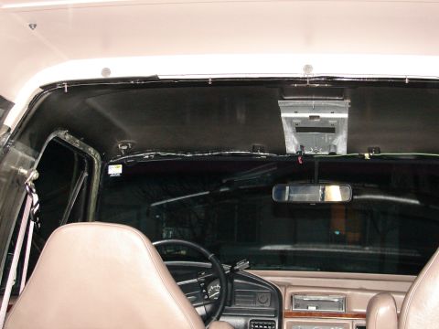 1996 Ford Bronco - The interior of the vehicle shows tan seats and a black headliner, with a view of the dashboard and windshield.