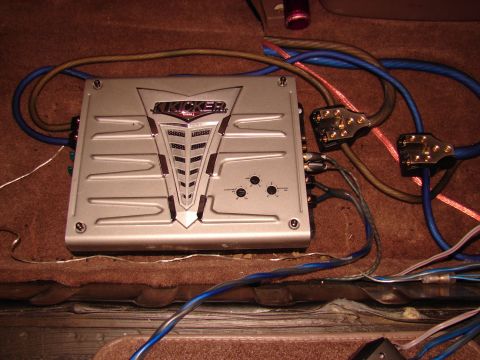 1996 Ford Bronco - Car amplifier and wiring installed in a vehicle's interior.
