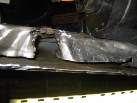 1986 Ford Bronco - Close-up view of a damaged and cut metal frame, likely from a vehicle modification or repair.