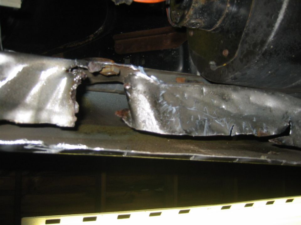 Cut metal frame with jagged edges and welding marks