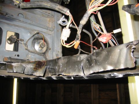1986 Ford Bronco - Close-up of modified metal frame with visible wiring harness and connectors.