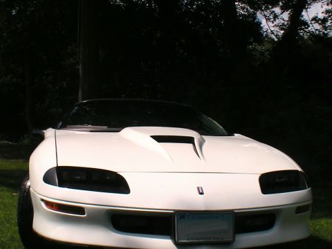 1996 Chevrolet Camaro - Front view of a white 1996 Chevrolet Camaro with a prominent aftermarket hood scoop.
