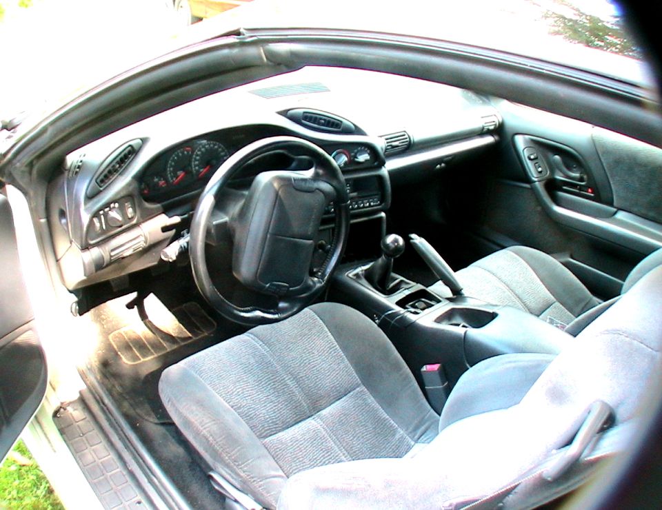 Interior view of a 1996 Chevrolet Camaro showing dashboard, steering wheel, and seats