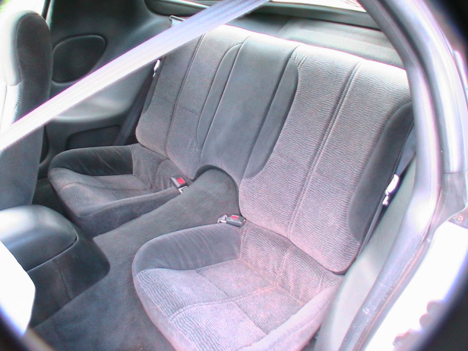 Gray fabric rear seats and seatbelts inside a car