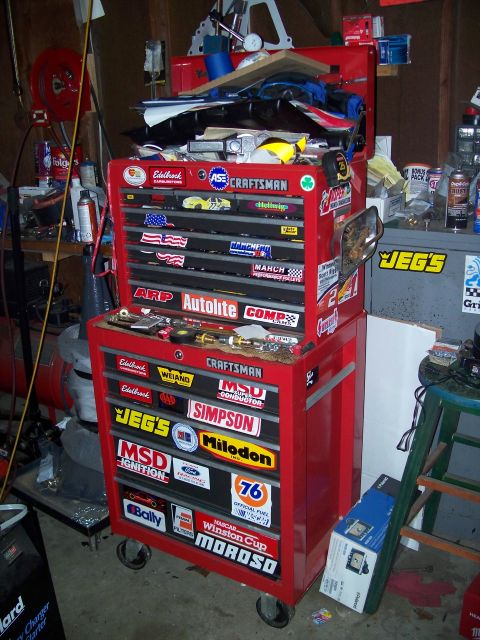 1971 Ford Ranchero - A red toolbox is covered in various racing stickers, including brands like Craftsman, Jegs, and Simpson.