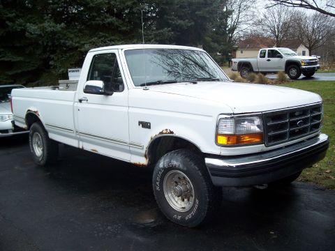 1971 Ford Ranchero - White Ford F-150 pickup truck, model years 1992-1996, parked outside with another truck in the background.