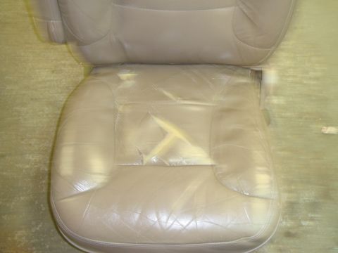 1996 Ford Bronco - The driver's side seat shows significant wear and tear, with a large rip on the cushion.