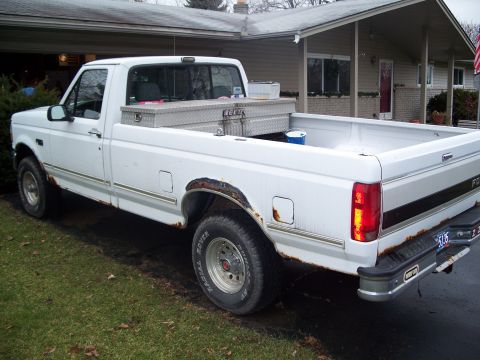 1971 Ford Ranchero - This white Ford F-150 pickup truck shows significant rust damage on its body and wheel wells.