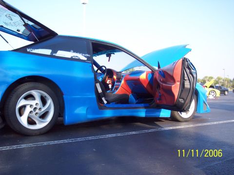 1995 Ford Probe - A modified 1995 Ford Probe is shown with its doors and hood open, revealing a custom interior.