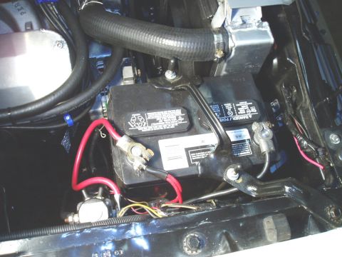 1966 Ford Fairlane - Engine bay view showing a car battery, radiator hose, and wiring. No specific vehicle year is identifiable.