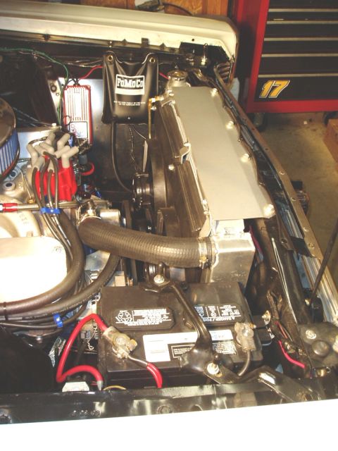 1966 Ford Fairlane - The engine bay contains a large aluminum radiator, battery, and ignition system with a 'FoMoCo' branded bag.