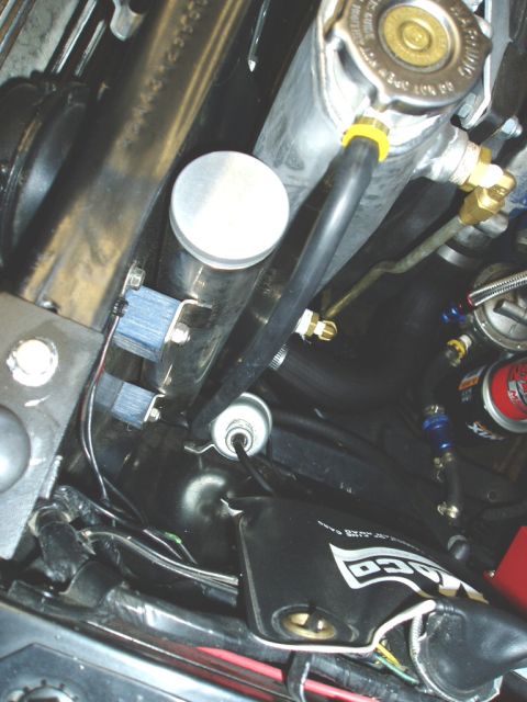 1966 Ford Fairlane - Close-up view of engine bay components including a radiator and overflow tank.