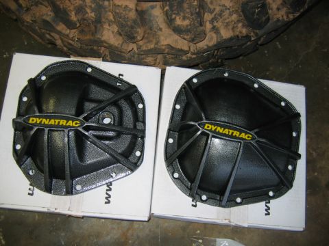 1992 Ford Mustang - Two Dynatrac differential covers are shown, resting on boxes with a tire tread visible above.