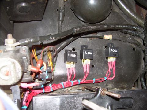 1984 Ford Bronco - A close-up view of an automotive wiring harness and relays, likely for auxiliary lighting.