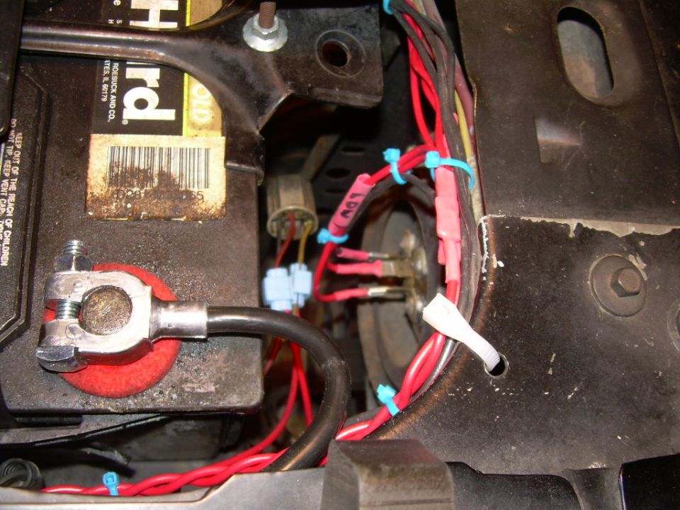 Battery and red wiring with blue zip ties, part of headlight rewire