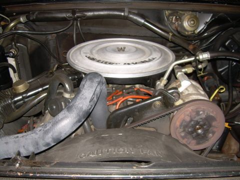 1984 Ford Bronco - The engine bay of a 1984 Ford Bronco shows a V8 engine with visible hoses, spark plug wires, and a fan shroud.