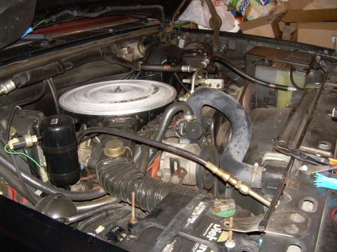 1984 Ford Bronco - Engine bay components including air cleaner, battery, and hoses are visible in this photo.