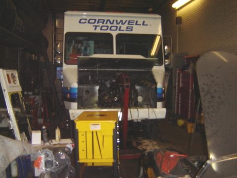 1992 Ford Bronco - A white truck with Cornwell Tools branding is in a garage with its hood open, revealing the engine.