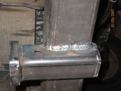 1994 Ford Bronco - Close-up of a newly welded metal hitch receiver, showing the weld beads.