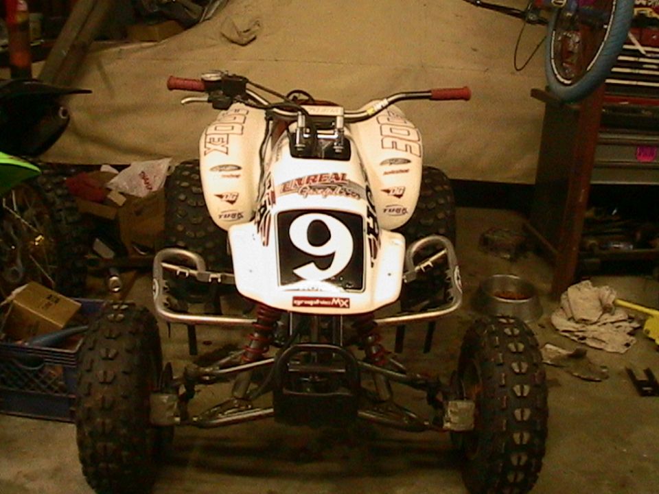 White quad bike with red handlebars and number 9 on the front. Some text graphics are visible on the body panels