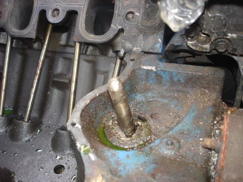 1979 Ford Bronco - Close-up view of internal engine components with visible wear and fluid residue.