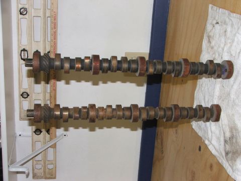 1965 Ford Mustang - Two engine camshafts are displayed side-by-side, showing their lobe profiles.