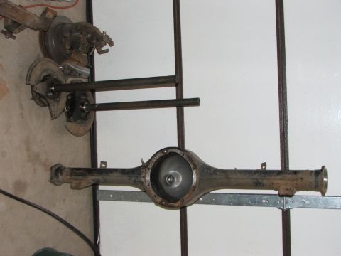 1965 Ford Mustang - A rear axle assembly and associated suspension components are displayed, with some signs of rust.
