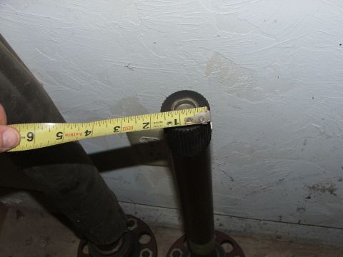 1965 Ford Mustang - Two axle shafts are measured with a tape measure, showing approximately 1.5 inches in diameter.