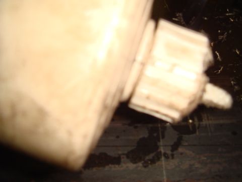 1996 Ford Bronco - Close-up of a cream-colored rear bumper component, showing layered construction and a protruding element.
