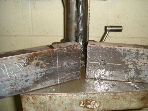 1996 Ford Bronco - Metal parts are being drilled on a drill press, with markings indicating measurements.