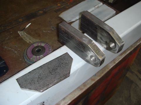 1996 Ford Bronco - Metal parts and grinding discs are laid out on a workbench, ready for fabrication.