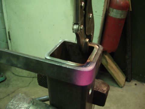 1996 Ford Bronco - Locking pliers grip a metal square tube during a fabrication process, likely for a custom bumper build.