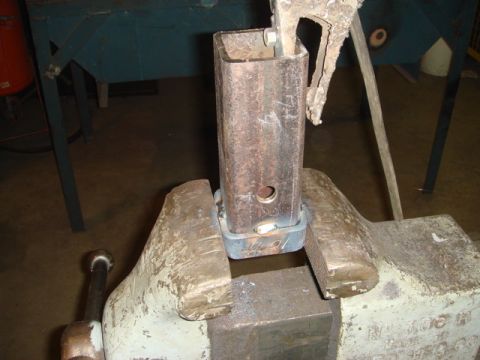 1996 Ford Bronco - A metal part is secured in a vise, ready for fabrication or repair.
