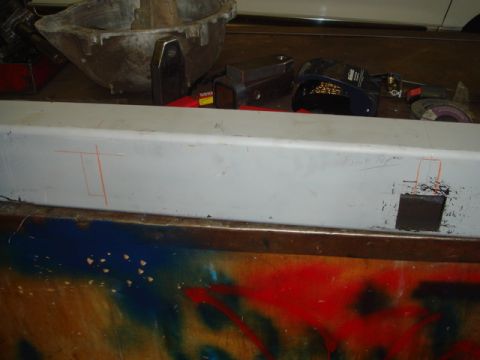 1996 Ford Bronco - A metal beam is marked with chalk lines and has a square cut out, with tools visible in the background.