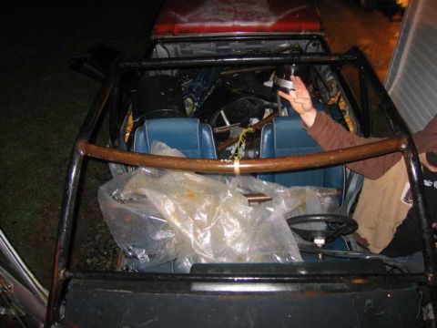 1984 Ford Bronco II - Interior of a vehicle with a roll cage and blue seats is visible.