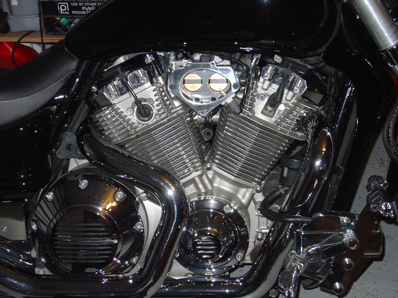 Chrome V-twin motorcycle engine close-up with polished cylinders and exhaust