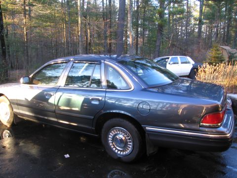 1991 Ford Crown Victoria LTD - A 1991 Ford Crown Victoria LTD sedan is parked in a driveway next to another vehicle.