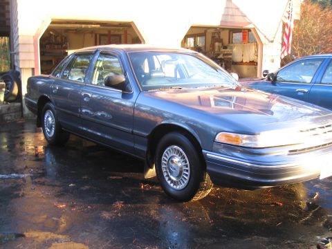 1991 Ford LTD Crown Victoria - Blue 1991 Ford Crown Victoria LTD sits in a wet driveway.