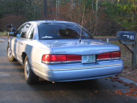 1991 Ford LTD Crown Victoria - Rear view of a light blue 1991 Ford Crown Victoria LTD sedan parked next to a mailbox.