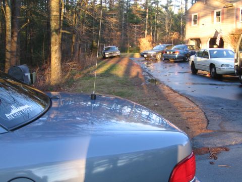 1991 Ford LTD Crown Victoria - Several cars are parked in a driveway on a sunny day, with a house visible.