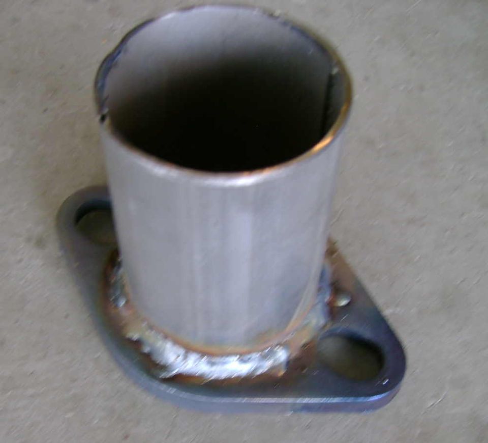Exhaust pipe flange with rough welds and two bolt holes