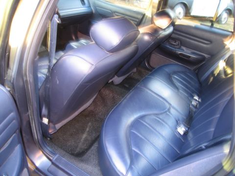 1991 Ford LTD Crown Victoria - Interior view of a 1991 Ford Crown Victoria LTD, showing the rear seats and door panel.
