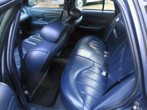 1991 Ford LTD Crown Victoria - Interior view of a 1991 Ford Crown Victoria LTD, highlighting the blue leather seats and seatbelts.