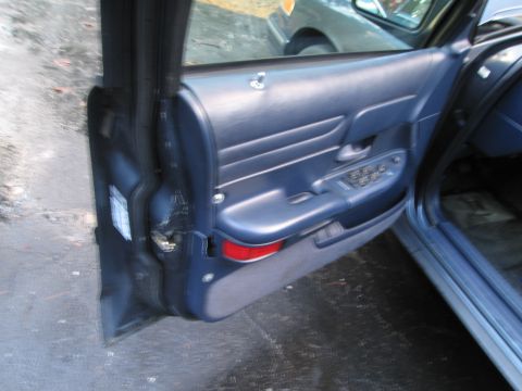 1991 Ford LTD Crown Victoria - The interior door panel of a 1991 Ford Crown Victoria LTD shows blue upholstery and window controls.