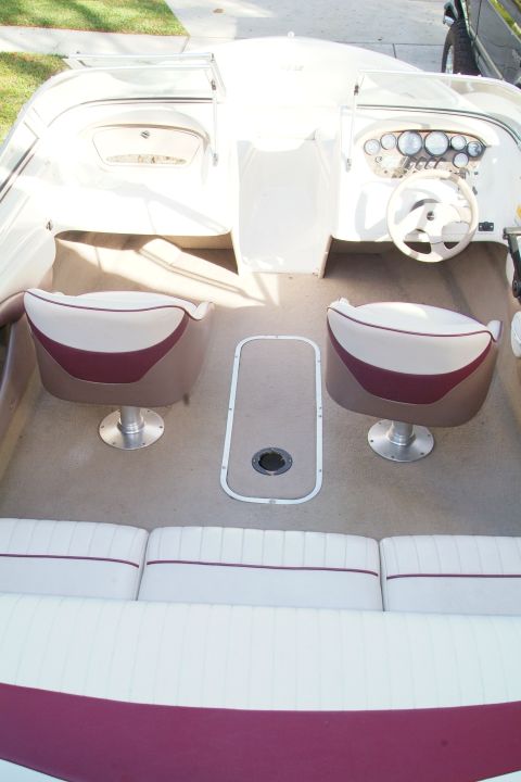 1995 Ford Bronco - The interior of a boat shows seating, a steering wheel, and dashboard instrumentation.