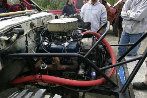 2003 Jeep TJ - Close-up of a custom engine bay in a modified off-road vehicle, with onlookers present.