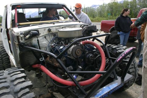 2003 Jeep TJ - This heavily modified vehicle features oversized tires and a prominent engine, suggesting it's built for extreme off-road use.
