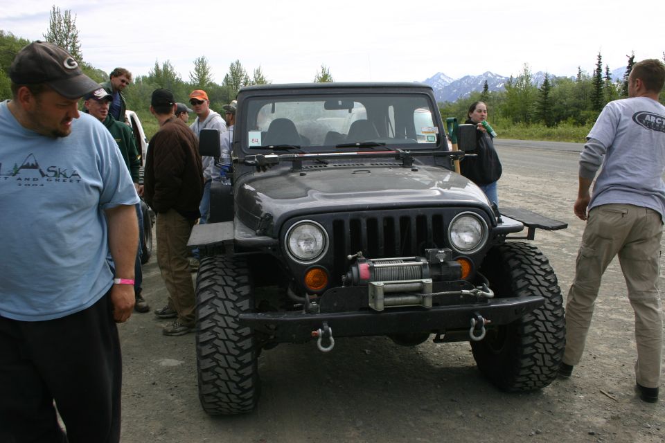Black Jeep Wrangler front view with winch and large tires