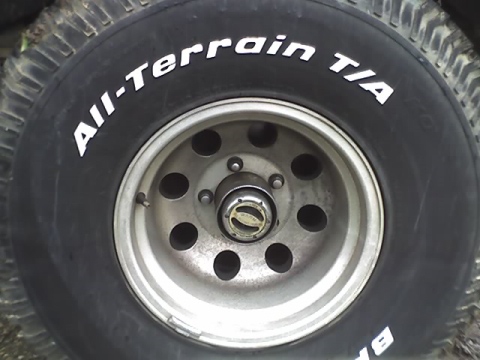 1979 Ford F-150 - Close-up of a BFGoodrich All-Terrain T/A tire mounted on a silver 5-lug wheel.